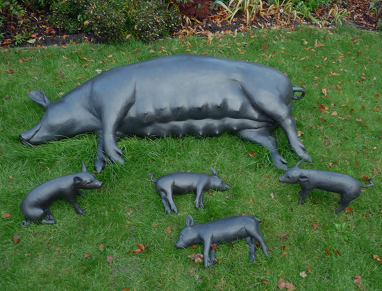 Dido Crosby Large Black Sow and four piglets in the sculpture garden at Messums, Lord's Wood.